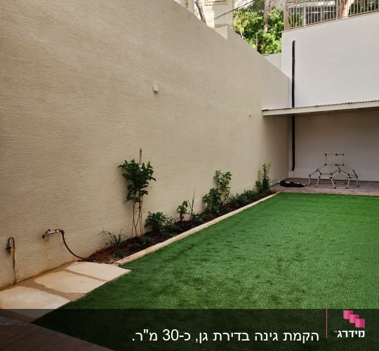 גינה מטופחת בבית פרטי עם דשא סינטטי, ערוגת צמחים ואבני מדרך